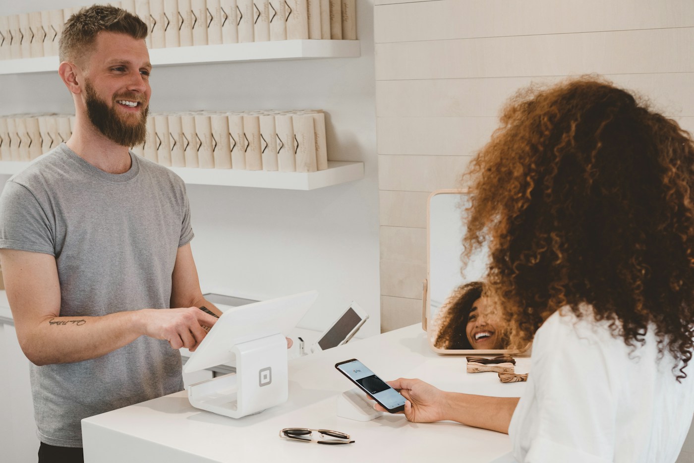 A customer paying at a small business counter